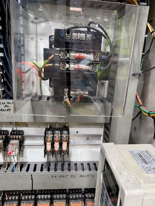 Electrical control panel with DC relays and circuit breakers for automation systems.